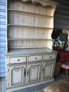 an old china cabinet is painted white