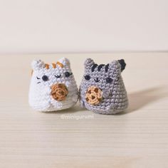 two small crocheted animals sitting next to each other