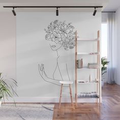 a drawing of a woman with flowers in her hair on a white background wall mural