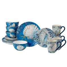 a blue and white dinnerware set with seashell designs