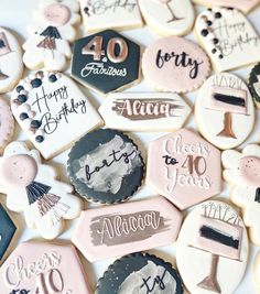 decorated cookies are arranged in the shape of birthdays and fortyth birthdays on display