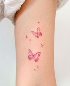 two pink butterflies on the back of a woman's right leg, with stars all over them