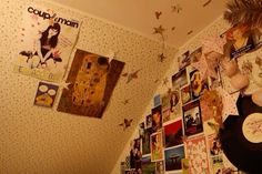 a wall covered in pictures and posters next to a record