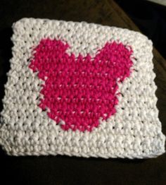 a crocheted square with a pink heart on it