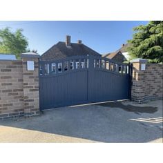 an image of a gated driveway with brick walls