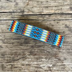 Gorgeous vintage Native American barrette made with blue and multicolored beads and leather.  Beadwork is a decorative and expressive art form in the Native American culture. Religious, nature and spiritual designs and patterns can be found in a variety of items from gauntlets to moccasins. DETAILS Artist: unknown Size: 5" L x 1" H  Materials: beads, leather Condition: Excellent - new Expressive Art, American Culture, Native American Culture, Loom Beading, Barrettes, Art Forms, Moccasins, Bead Work, Loom