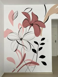 a white wall with pink and black flowers painted on it