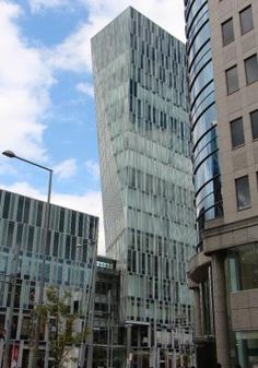 two tall buildings next to each other on a city street