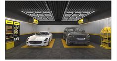 two cars are parked in a garage with yellow and black flooring on the walls