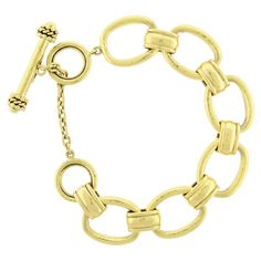 Unlock the beauty of Elizabeth Locke's Oval Link Open Bracelet. Made with 19kt yellow gold, this toggle clasp bracelet weighs a luxurious 51.5 grams. Elevate your style with this stunning piece and make a statement wherever you go. A must-have for any fashion lover! Length: 7 inches without the chain and toggle, 9 inches including the chain and toggle. Elizabeth Locke, Toggle Clasp Bracelet, Open Bracelet, Clasp Bracelet, Bracelet Clasps, Toggle Clasp, Fashion Lover, Link Bracelets, Arm Band