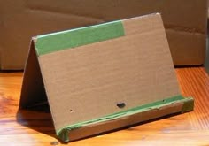 an open cardboard box sitting on top of a wooden table