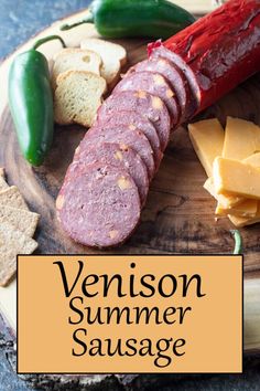 a wooden plate topped with different types of cheese and meats next to crackers