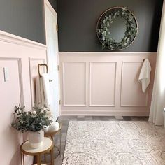 a bathroom with gray walls and white rugs on the floor next to a toilet