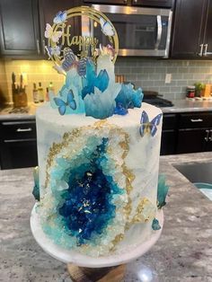 a white and blue cake sitting on top of a counter