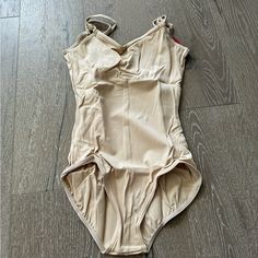 This Nice Leotard From Capezio Features Adjustable Straps, A Cami Design And Pull-On Style. New With Tags Size Medium Summer Shaping Bodysuit In Beige, Summer Shaping Beige Bodysuit, Beige Shaping Bodysuit For Summer, Summer Beige Shaping Bodysuit, Fitted Beige Bodysuit With Lined Body, Fitted Beige Lined Bodysuit, Fitted Beige Shapewear Bodysuit, Beige Fitted Shapewear Bodysuit, Fitted One-piece Leotard With Built-in Bra