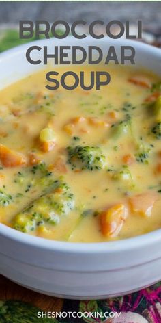 broccoli cheddar soup in a white bowl on a colorful tablecloth