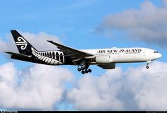 an air new zealand plane flying in the sky with clouds behind it and blue skies above