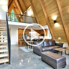 a living room filled with furniture next to a stair case in a loft style home