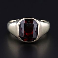 This vintage ring (circa 1925-1935) features a radiant cut almandine-spessarite garnet set in pale 14k yellow gold. The ring is currently a size 9, but it can be resized free of charge. It is in very good condition with light surface wear to the gold and to the facets of the garnet.  The ring weighs 9.87 grams.  We have many other fantastic offerings of period fine jewelry posted on our Etsy store, so please consider browsing our other items. We send all items in individually packaged gift boxes and offer layaway plans! + Trademark Antiques Shop Homepage https://www.etsy.com/shop/TrademarkAntiques + Our Store Policies https://www.etsy.com/shop/TrademarkAntiques/policy?ref=shopinfo_policies_leftnav + Connect with us on Social Media (Get access to monthly giveaways, special sales, and sneak Formal Ruby Signet Ring In Fine Jewelry Style, Ruby Signet Ring Fine Jewelry For Formal Events, Fine Jewelry Ruby Signet Ring For Formal Occasions, Classic Red Signet Ring For Formal Occasions, Ruby Signet Ring For Formal Occasions, Classic Formal Gemstone Signet Ring, Classic Red 14k Gold Signet Ring, Classic Formal Signet Ring With Gemstone, Classic 14k Gold Red Signet Ring