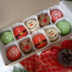 twelve decorated christmas cookies in a box