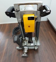 a floor sander sitting on top of a hard wood floor next to a wall