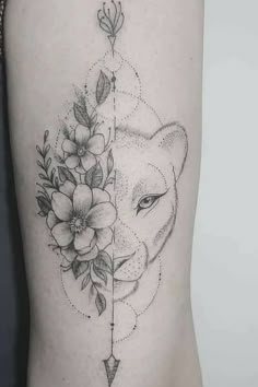 a woman's thigh with flowers and an arrow on it