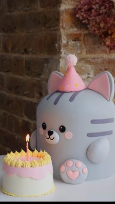 a cat cake with a candle on it