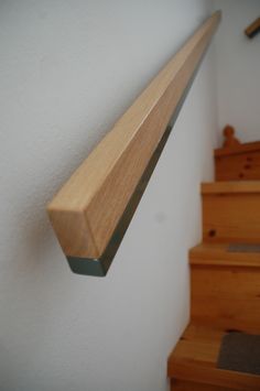 there is a wooden hand rail on the wall