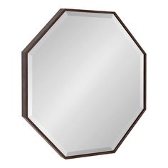 a mirror that is on the wall and has a brown frame with a hexagonal shape