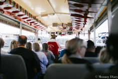 people are sitting on a bus and looking out the window