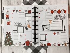 an open planner with christmas decorations on it