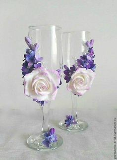 two wine glasses decorated with purple and white flowers