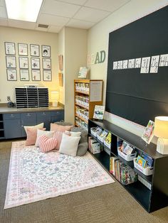 a room with several bookshelves and various items on the floor in front of it