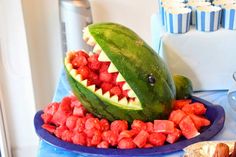 there is a watermelon that has been carved to look like a shark