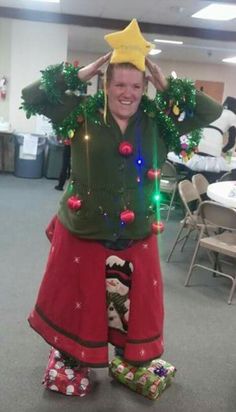 a woman is dressed up as a christmas tree