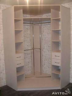 an empty walk in closet with shelves and cupboards on the wall next to it