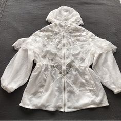 Nwot Mishang Ge Ge Unique Windbreaker Jacket Zip Up W/ Hood White Lace Sequins Beads Mesh Trimmed Balloon Sleeves Drawstring Waist Pockets Super Soft And Lightweight Size L Approx 28” Long And 23” Across Chest Best Offers Welcome. Message Me Or Send An Offer In! White Embroidered Hooded Outerwear, Vintage Windbreaker Jacket, Hooded Jean Jackets, Black Raincoat, Navy Denim Jacket, Barbour Women, Welcome Message, Raincoat Jacket, Hooded Rain Jacket