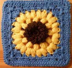 a crocheted square with a sunflower on it