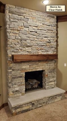 a stone fireplace in a living room with a sign above it that reads, shown in clear finish