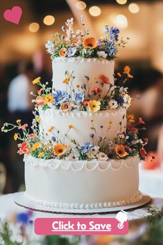 a three tiered cake with flowers on the top is for sale at a wedding