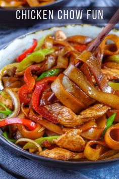 chicken chow fun stir fry in a bowl with chopsticks on the side and text overlay