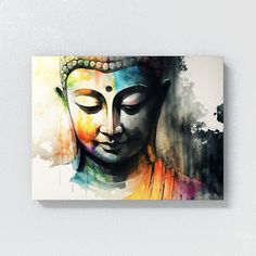 a painting of a buddha head on a wall with paint splattered over it