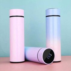 two pink and white thermos sitting next to each other on top of a table