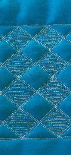 the blue quilt is stitched together to make it look like they have been made out of