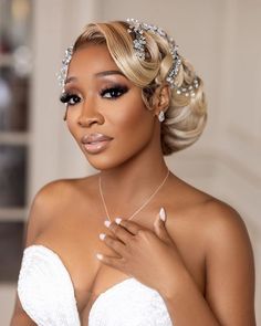 a woman in a wedding dress wearing a tiara and pearls on her head is posing for the camera