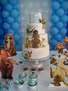 an image of a birthday cake and cupcakes with animals on it in front of balloons