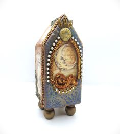 an ornate blue and gold box with a painting on it