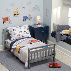 a child's bedroom with blue walls and furniture