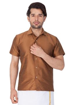 Vastramay brings to you this Stylish yet Comfortable Men Coffee Ethnic South Indian Shirt. Adorn it for a perfect Classy and Trendy look. These Shirts are usually very popular in Souther part of the Sub Continent. These are also called Madras Shirt. It is worn along with a trouser or a jeans. However, traditionally it is paired with a mundu or a white dhoti. The set is also called as Shirt Vesty.Product Features :  Top Color: Brown Top Fabric: Cotton Art Silk Product Type: Ethnic South Indian Sh Traditional Brown Festive Tops, Festive Traditional Brown Tops, Festive Brown Traditional Tops, Madras Shirt, Mens Half Sleeve, Stylish Shirts Men, Cotton Art, Men Coffee, Cutaway Collar