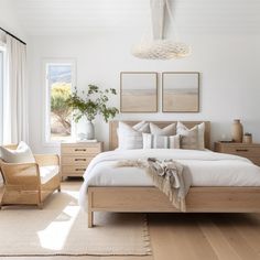 a bedroom with white walls and wooden furniture, including a large bed in the center